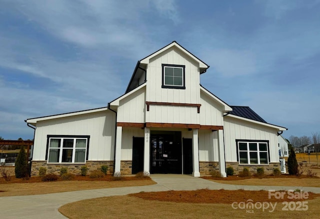 1817 Ab Moore Jr Dr Unit 3240, Indian Trail, NC 28079 - modern farmhouse style home featuring stone siding, board and batten siding, and a standing seam roof