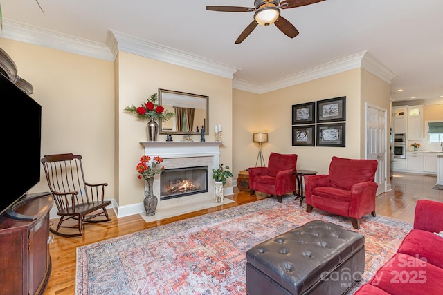 9210 Ginhouse Ln, Charlotte, NC 28277 - living area featuring wood finished floors, a ceiling fan, a high end fireplace, crown molding, and recessed lighting