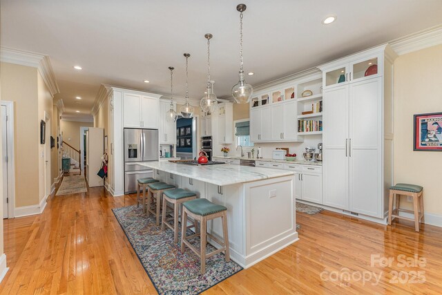 9210 Ginhouse Ln, Charlotte, NC 28277 - kitchen featuring stainless steel refrigerator with ice dispenser, open shelves, a kitchen bar, ornamental molding, and a kitchen island