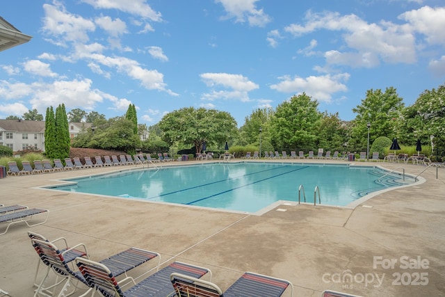 9210 Ginhouse Ln, Charlotte, NC 28277 - community pool featuring a patio area and view of wooded area