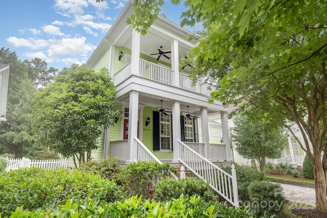 9210 Ginhouse Ln, Charlotte, NC 28277 - view of front of home with a ceiling fan, a balcony, covered porch, and stairs