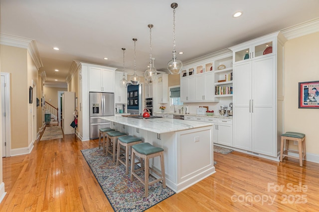 9210 Ginhouse Ln, Charlotte, NC 28277 - kitchen featuring stainless steel fridge, open shelves, a kitchen breakfast bar, ornamental molding, and a center island