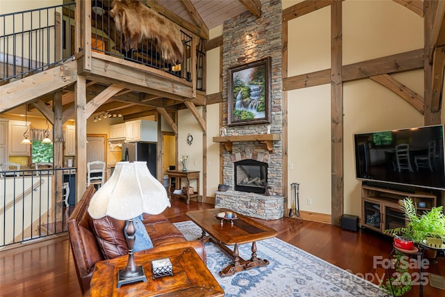 649 Panoramic Loop, Maggie Valley, NC 28751 - living area featuring high vaulted ceiling, hardwood / wood-style floors, baseboards, wooden ceiling with exposed beams, and a stone fireplace
