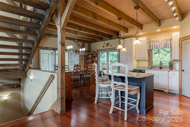 649 Panoramic Loop, Maggie Valley, NC 28751 - kitchen with wooden ceiling with exposed beams, healthy amount of natural light, a kitchen breakfast bar, dark wood-style floors, and a chandelier
