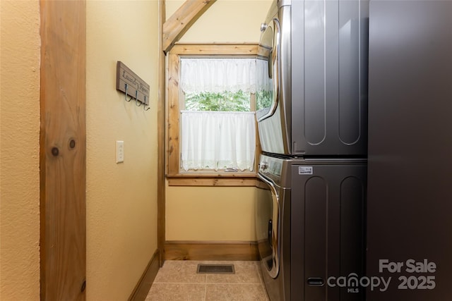 649 Panoramic Loop, Maggie Valley, NC 28751 - laundry room with stacked washer / drying machine, tile patterned floors, and baseboards