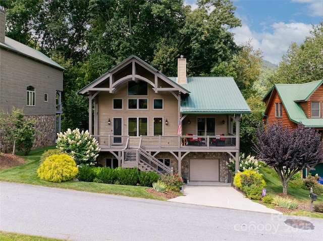 649 Panoramic Loop, Maggie Valley, NC 28751 - view of front of home with stone siding, a chimney, stairway, concrete driveway, and a porch