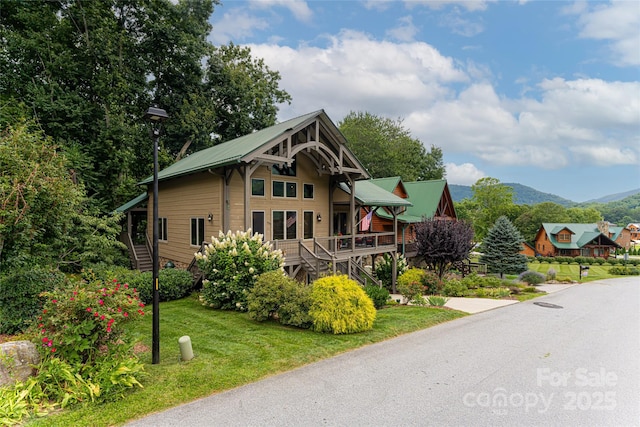 649 Panoramic Loop, Maggie Valley, NC 28751 - rustic home with stairs, metal roof, a front yard, and a deck with mountain view