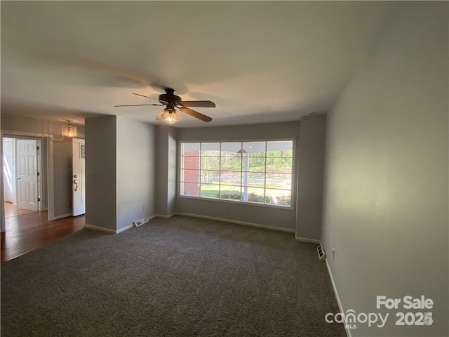 2405 Forrestbrook Dr, Kannapolis, NC 28083 - spare room featuring dark carpet, baseboards, and a ceiling fan