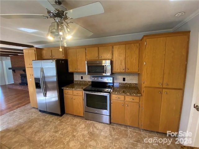 2405 Forrestbrook Dr, Kannapolis, NC 28083 - kitchen featuring appliances with stainless steel finishes, crown molding, a ceiling fan, brown cabinets, and dark stone countertops