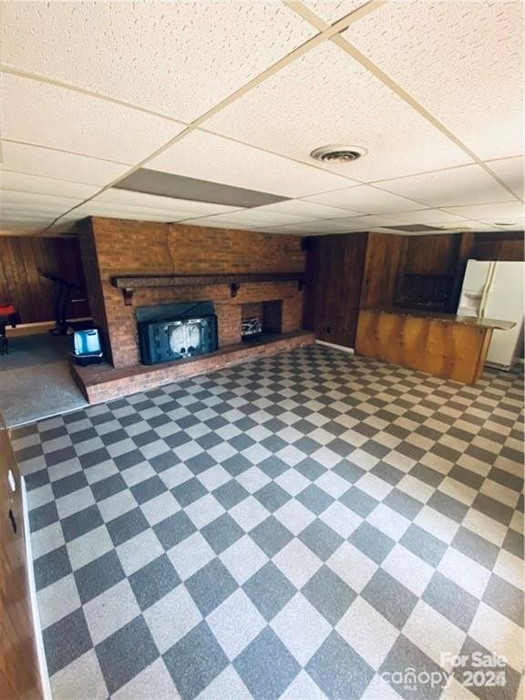 2405 Forrestbrook Dr, Kannapolis, NC 28083 - unfurnished living room featuring a fireplace, tile patterned floors, wooden walls, and a paneled ceiling