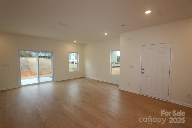 222 Harpers Run Ln, Matthews, NC 28104 - empty room with plenty of natural light, wood finished floors, recessed lighting, and baseboards