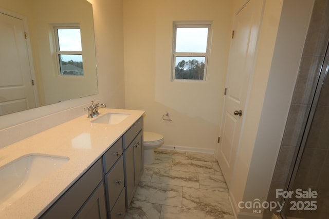 222 Harpers Run Ln, Matthews, NC 28104 - bathroom with marble finish floors, double vanity, toilet, and baseboards