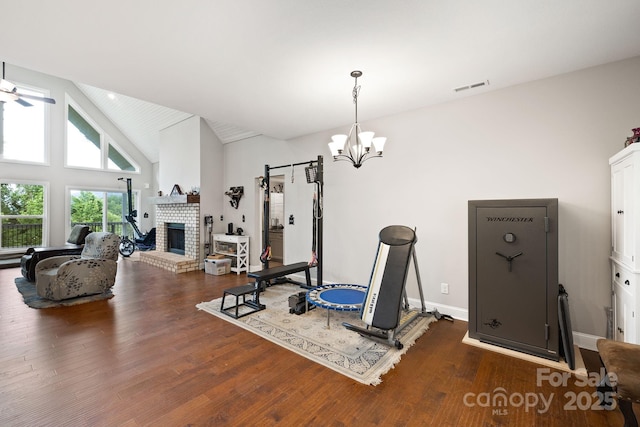 771 Sally Gap Rd, Old Fort, NC 28762 - exercise area with a chandelier, wood finished floors, a brick fireplace, and high vaulted ceiling
