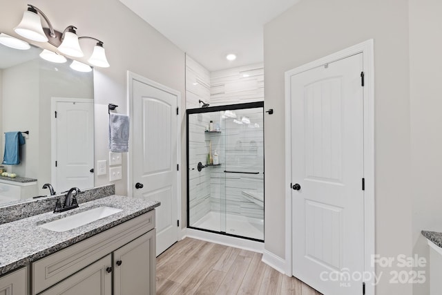 771 Sally Gap Rd, Old Fort, NC 28762 - bathroom with a stall shower, vanity, and wood finished floors