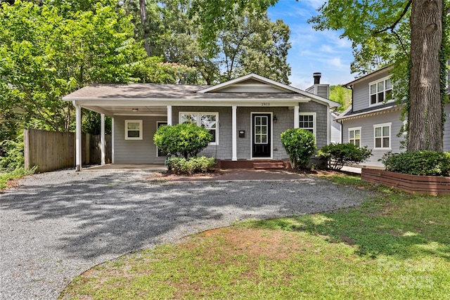 2813 Hilliard Dr, Charlotte, NC 28205 - view of front facade featuring gravel driveway, a carport, a chimney, a shingled roof, and a porch