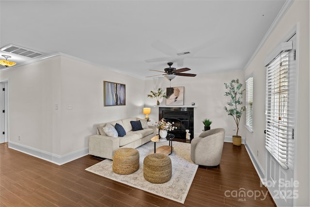 2813 Hilliard Dr, Charlotte, NC 28205 - living area featuring plenty of natural light, ornamental molding, a ceiling fan, wood finished floors, and a high end fireplace
