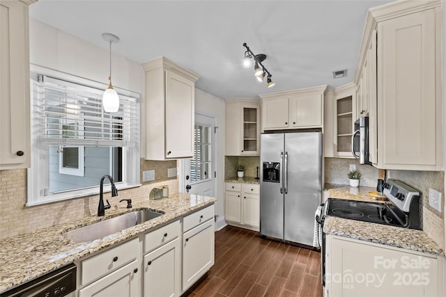 2813 Hilliard Dr, Charlotte, NC 28205 - kitchen with appliances with stainless steel finishes, dark wood-style flooring, and backsplash
