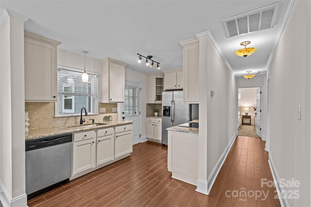 2813 Hilliard Dr, Charlotte, NC 28205 - kitchen featuring appliances with stainless steel finishes, dark wood-style floors, backsplash, pendant lighting, and light stone countertops