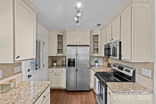 2813 Hilliard Dr, Charlotte, NC 28205 - kitchen featuring stainless steel appliances, tasteful backsplash, dark wood-style flooring, and glass insert cabinets