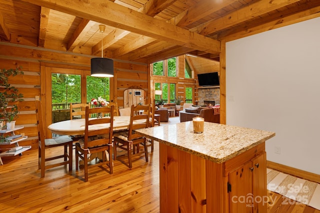 2255 Wolf Laurel Rd, Mars Hill, NC 28754 - dining area with wood ceiling with exposed beams, light wood-type flooring, baseboards, and a fireplace