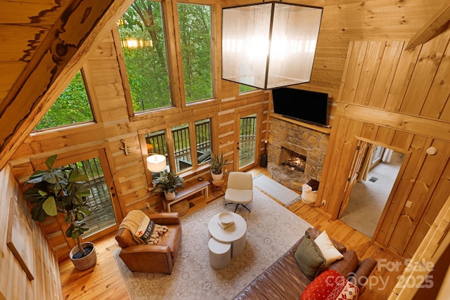 2255 Wolf Laurel Rd, Mars Hill, NC 28754 - living room with wood finished floors, wooden walls, and a stone fireplace