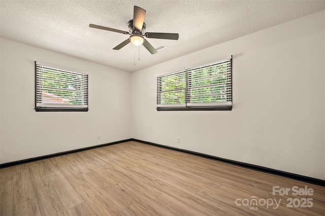 1214 Northwoods Dr, Kings Mountain, NC 28086 - spare room with light wood-style flooring, baseboards, a textured ceiling, and a ceiling fan
