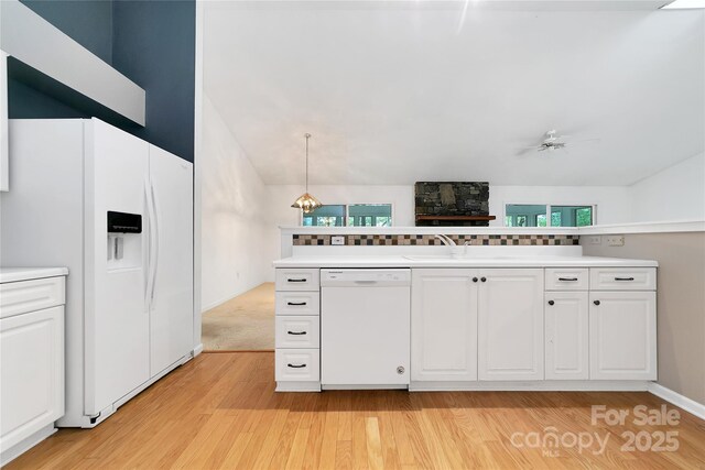 4404 Connestee Trl, Brevard, NC 28712 - kitchen featuring white appliances, light wood-type flooring, white cabinets, light countertops, and lofted ceiling