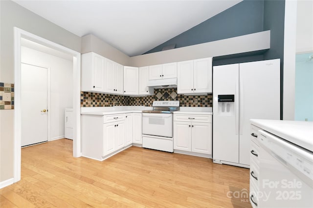 4404 Connestee Trl, Brevard, NC 28712 - kitchen with white appliances, decorative backsplash, lofted ceiling, light countertops, and premium range hood