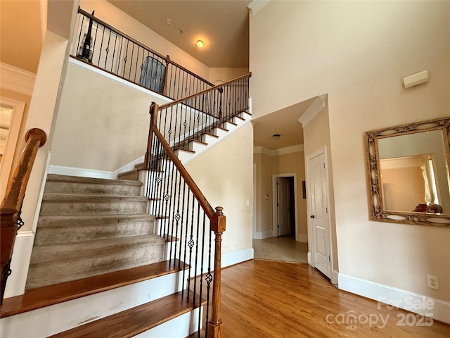8620 Rolling Fields Rd, Charlotte, NC 28227 - stairs with a high ceiling, wood finished floors, baseboards, and ornamental molding