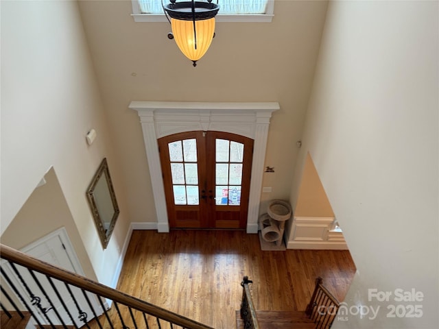 8620 Rolling Fields Rd, Charlotte, NC 28227 - entryway featuring french doors, wood finished floors, a towering ceiling, and stairs