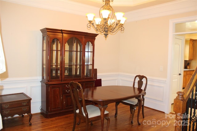8620 Rolling Fields Rd, Charlotte, NC 28227 - dining room with a chandelier, a wainscoted wall, a decorative wall, wood finished floors, and ornamental molding