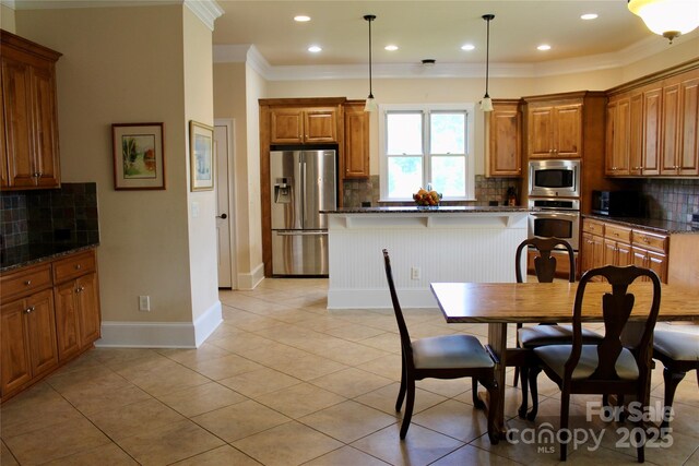 8620 Rolling Fields Rd, Charlotte, NC 28227 - kitchen featuring stainless steel appliances, crown molding, backsplash, brown cabinets, and recessed lighting