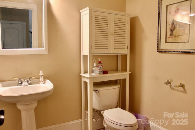 8620 Rolling Fields Rd, Charlotte, NC 28227 - bathroom featuring toilet, baseboards, and a sink