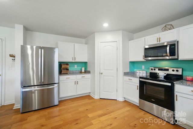 124 Vintage Woods Ct, Shelby, NC 28150 - kitchen featuring appliances with stainless steel finishes, white cabinets, light wood-type flooring, light stone counters, and recessed lighting