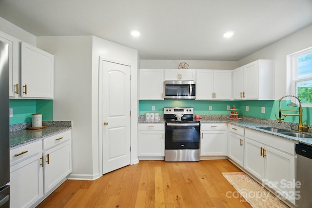 124 Vintage Woods Ct, Shelby, NC 28150 - kitchen with appliances with stainless steel finishes, light wood-style floors, white cabinetry, light stone counters, and recessed lighting