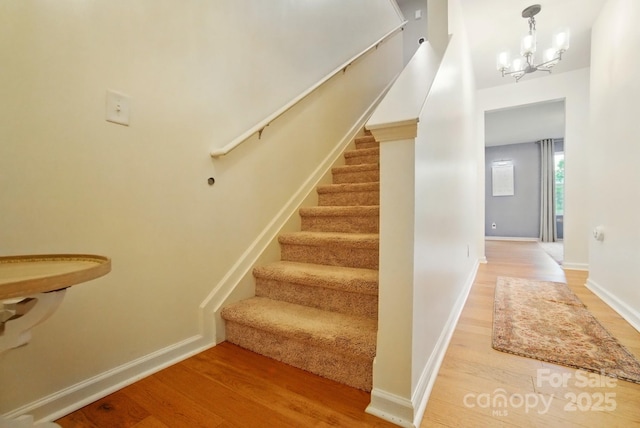 124 Vintage Woods Ct, Shelby, NC 28150 - staircase featuring wood finished floors and a chandelier