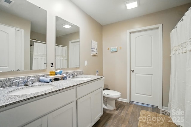 124 Vintage Woods Ct, Shelby, NC 28150 - bathroom with wood finished floors, double vanity, and a shower with curtain