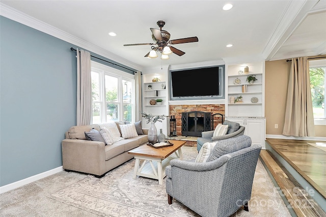 1011 Bydeford Ct, Matthews, NC 28105 - living area featuring crown molding, a ceiling fan, baseboards, a stone fireplace, and recessed lighting
