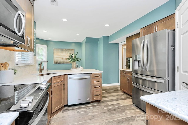 1011 Bydeford Ct, Matthews, NC 28105 - kitchen with appliances with stainless steel finishes, a sink, light countertops, a peninsula, and recessed lighting