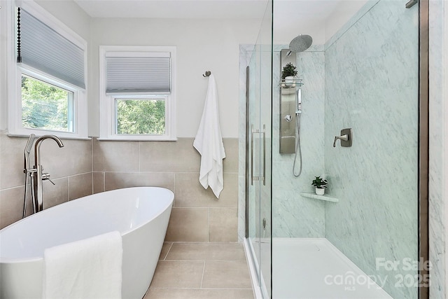 1011 Bydeford Ct, Matthews, NC 28105 - full bathroom with a stall shower, a freestanding tub, tile patterned flooring, tile walls, and wainscoting