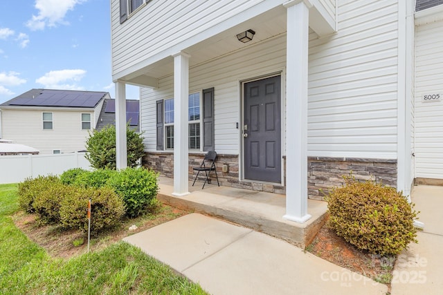 8005 Stevie Oaks Ln, Charlotte, NC 28215 - doorway to property featuring covered porch and stone siding