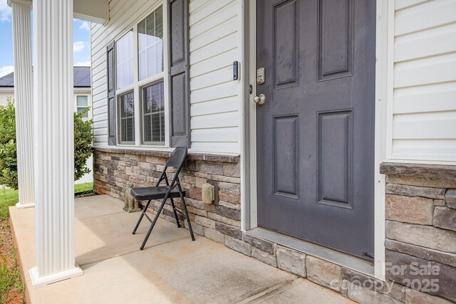 8005 Stevie Oaks Ln, Charlotte, NC 28215 - view of exterior entry with stone siding and covered porch