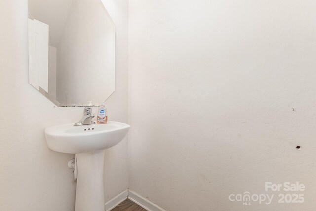 8005 Stevie Oaks Ln, Charlotte, NC 28215 - bathroom featuring baseboards and a sink