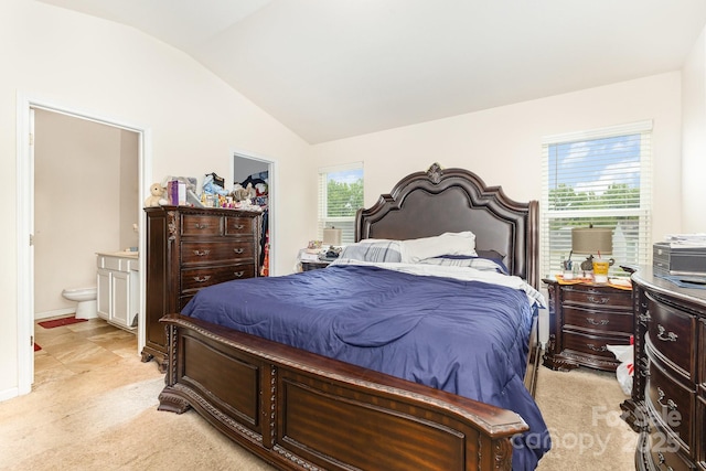 8005 Stevie Oaks Ln, Charlotte, NC 28215 - bedroom with vaulted ceiling, light colored carpet, a walk in closet, connected bathroom, and a closet