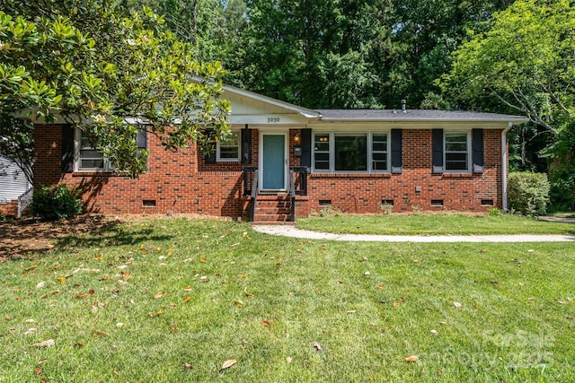 3939 Sheffield Dr, Charlotte, NC 28205 - view of front of house featuring crawl space, a front yard, and brick siding