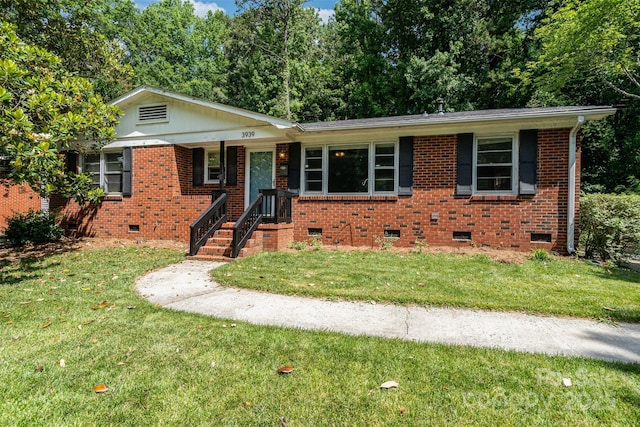 3939 Sheffield Dr, Charlotte, NC 28205 - view of front of house featuring crawl space, a front yard, and brick siding
