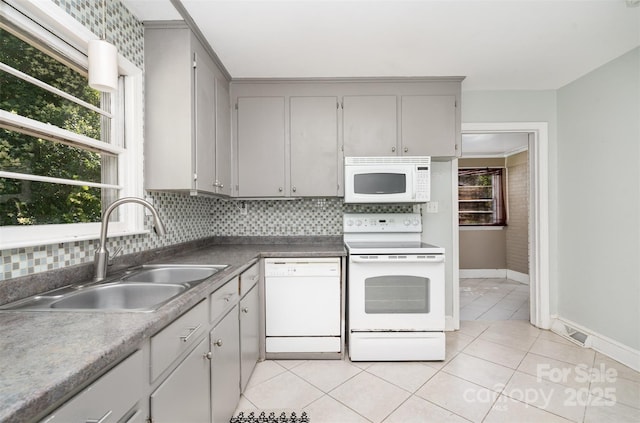 3939 Sheffield Dr, Charlotte, NC 28205 - kitchen featuring white appliances, light tile patterned floors, tasteful backsplash, and gray cabinets