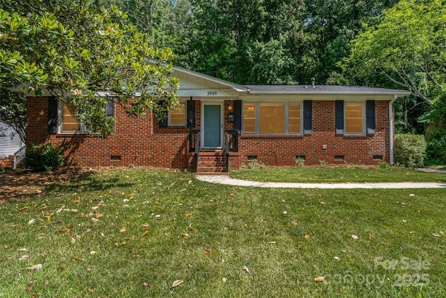 3939 Sheffield Dr, Charlotte, NC 28205 - view of front of home with crawl space, a front yard, and brick siding