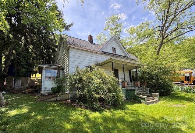 15 Vine St, Canton, NC 28716 - view of side of home featuring a lawn, a chimney, and a porch