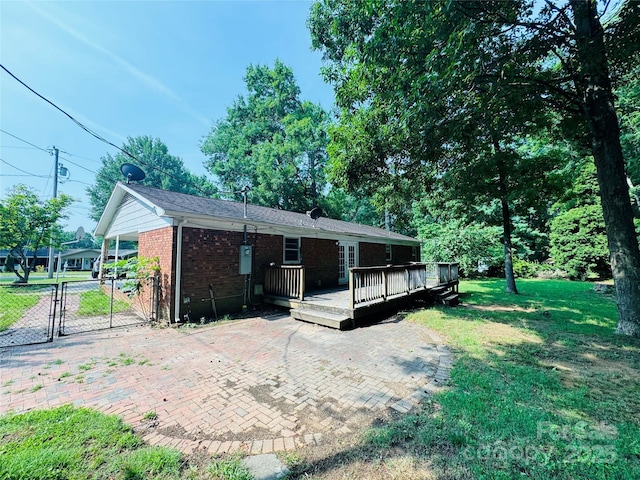 316 Meadowood Cir, Kannapolis, NC 28081 - view of front of property with a gate, a front yard, a deck, brick siding, and a patio